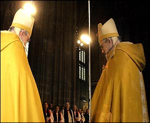 A mirror reflects Dr Williams and clergy