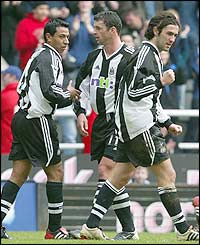 Newcastle players celebrate Hasselbaink's own goal