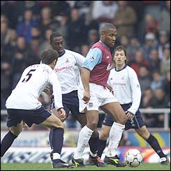 West Ham's Les Ferdinand is given close attention by the Spurs defence