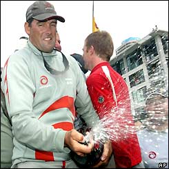 Alinghi skipper Russell Coutts sprays the champagne