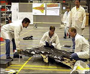 Technicians move shuttle debris
