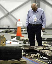 Nasa technician examines debris