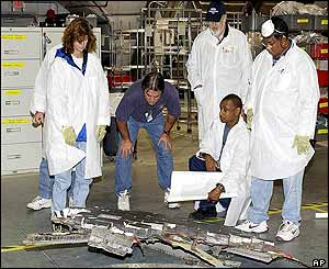 Technicians check shuttle debris
