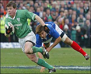 Ireland's captain Brian O'Driscoll sprints clear of Francois Gelez