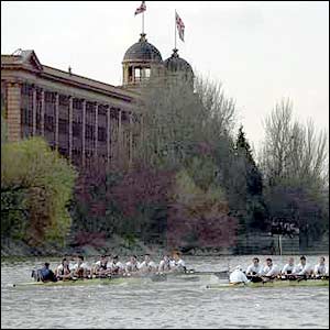 The crews row past the Harrods Wharf landmark in 1997