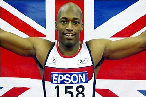 Marlon Devonish waves the Union Jack to celebrate winning the 200m