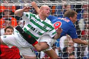 Celtic's John Hartson battles with Ronald de Boer in the air