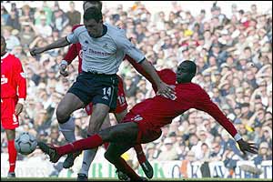 Liverpool's Djimi Traore slides in against Spurs' Gus Poyet