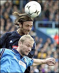 Birmingham forward Christophe Dugarry rises above Manchester City's Gerard Wiekens