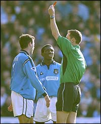 Manchester City defender Niclas Jensen is sent off by referee Matt Messias, to the disbelief of Shaun-Wright Phillips (centre)
