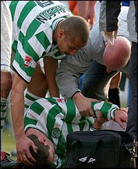 Celtic striker Henrik Larsson shows his concern as team-mate Chris Sutton lies injured