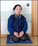 Echio Sato on traditional mats in front of sliding doors 