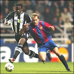 Newcastle's Olivier Bernard holds off the challenge of Barcelona's Gabri