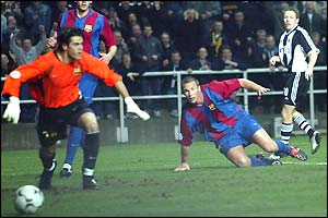 Barcelona keeper Victor Valdes scrambles back towards his goal as Craig Bellamy's shot hits the post