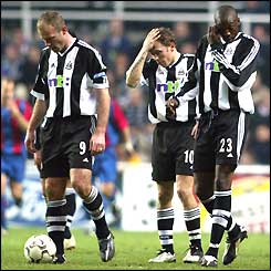 Alan Shearer, Craig Bellamy and Shola Ameobi leave the St. James' Park pitch looking upset after their defeat