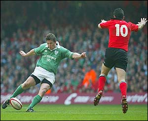 Brian O'Driscoll goes for a drop goal as Wales' Stephen Jones tries to block