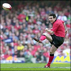 Welsh fly-half Stephen Jones scores a late drop goal against Ireland