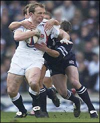 Nathan Hines of Scotland tries to tackle England scrum-half Matt Dawson 