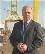 Rob stands in the deserted shipyard