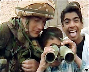 A coalition forces soldier tries to win over the children of Umm Qasr