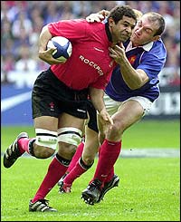 Wales' Colin Charvis is tackled by France's Olivier Brouzet