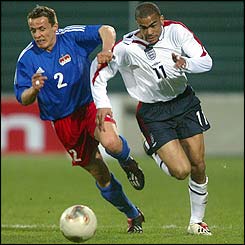 Liechtenstein's Martin Telser is unable to keep up with England speed merchant Kieron Dyer