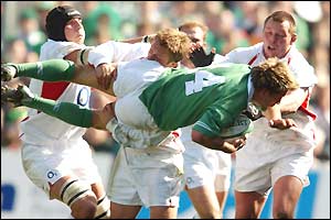 Ireland's Justin Bishop is lifted off his feet by the England defence