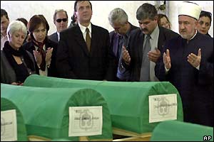 The head of Bosnian Muslim community, Mufti Mustafa Ceric, prays in front of coffins 