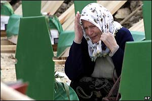 A Bosnian Muslim woman weeps at a grave 
