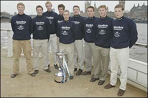 The Oxford crew pose with the trophy on the banks of the Thames
