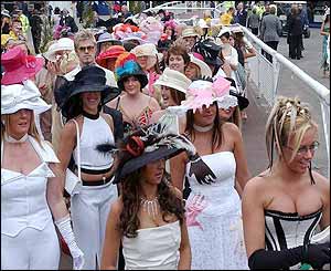 Racing fans line up to enter a competition for the best dressed racegoer