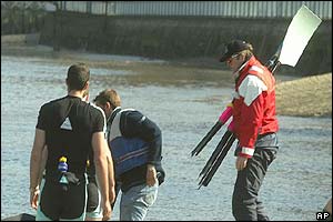A coach from Cambridge carries two broken oars after the boat was involved in a collision with a Harbour Master launch