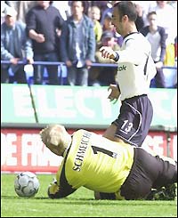 Peter Schmeichel brings down Youri Djorkaeff 25 minutes into the match
