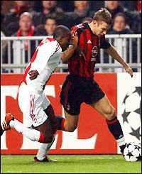 Ajax's Hatem Trabelsi tries to hold off Milan striker Andriy Shevchenko 