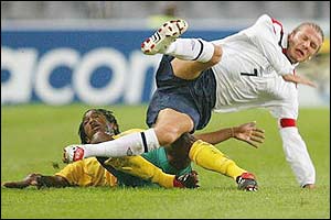 South Africa's Thabang Molefe tackles England captain David Beckham