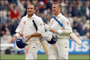 Mark Butcher and Alec Stewart walk off the field after a rain break