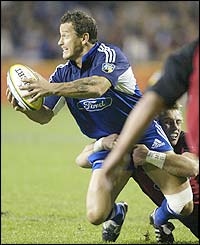 Carlos Spencer attempts to launch an attack for the Auckland Blues