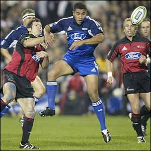 Mils Muliaina of the Blues contests a high ball with Leon Macdonald