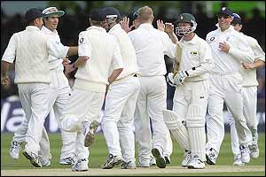 England players celebrate taking the wicket of Grant Flower