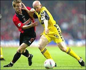 Bournemouth's Wade Elliot, left, battles with Lincoln City's Stuart Bimson
