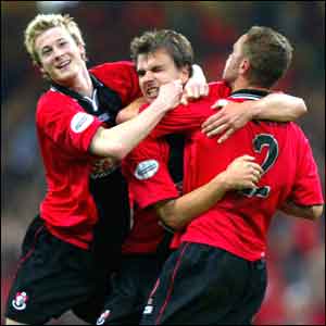 Carl Fletcher is swamped by his team-mates 