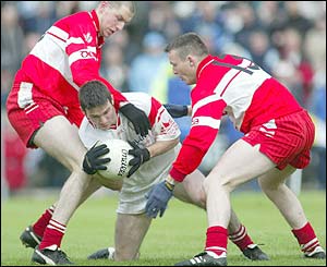 Ciaran Gourley holds on to possession at Casement Park