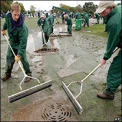 Greenkeepers at Augusta continue to use squeegees on the drenched course