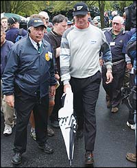 South Africa's Ernie Els makes his way back to the clubhouse after play is cancelled on the first day 