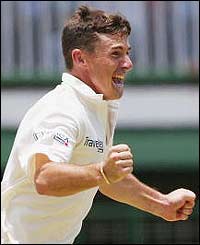 Australia spinner Brad Hogg celebrates the wicket of Wavell Hinds