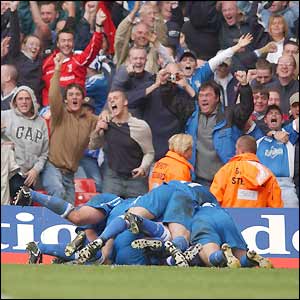 Rangers players mob their team-mate Andy Campbell after he scores the goal which secures promotion