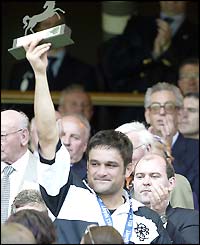 Barbarians captain Taine Randell celebrates with the trophy