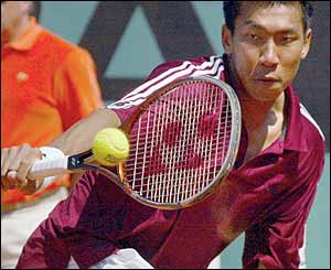 Thailand's Paradorn Srichaphan hits a return against Slovakian opponent Dominik Hrbaty