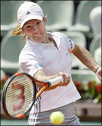Belgium's Justine Henin-Hardenne strikes a forehand return