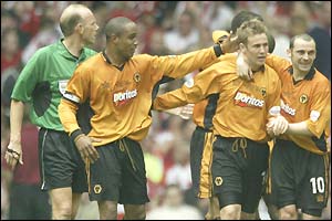 Kenny Miller is congratulated by his team-mates after scoring Wolves' third goal